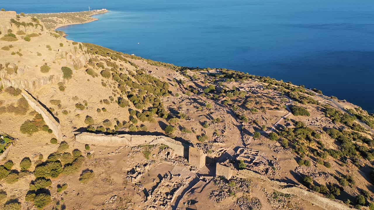 Aerial view of Assos Ancient City with its forification walls and monumental gate